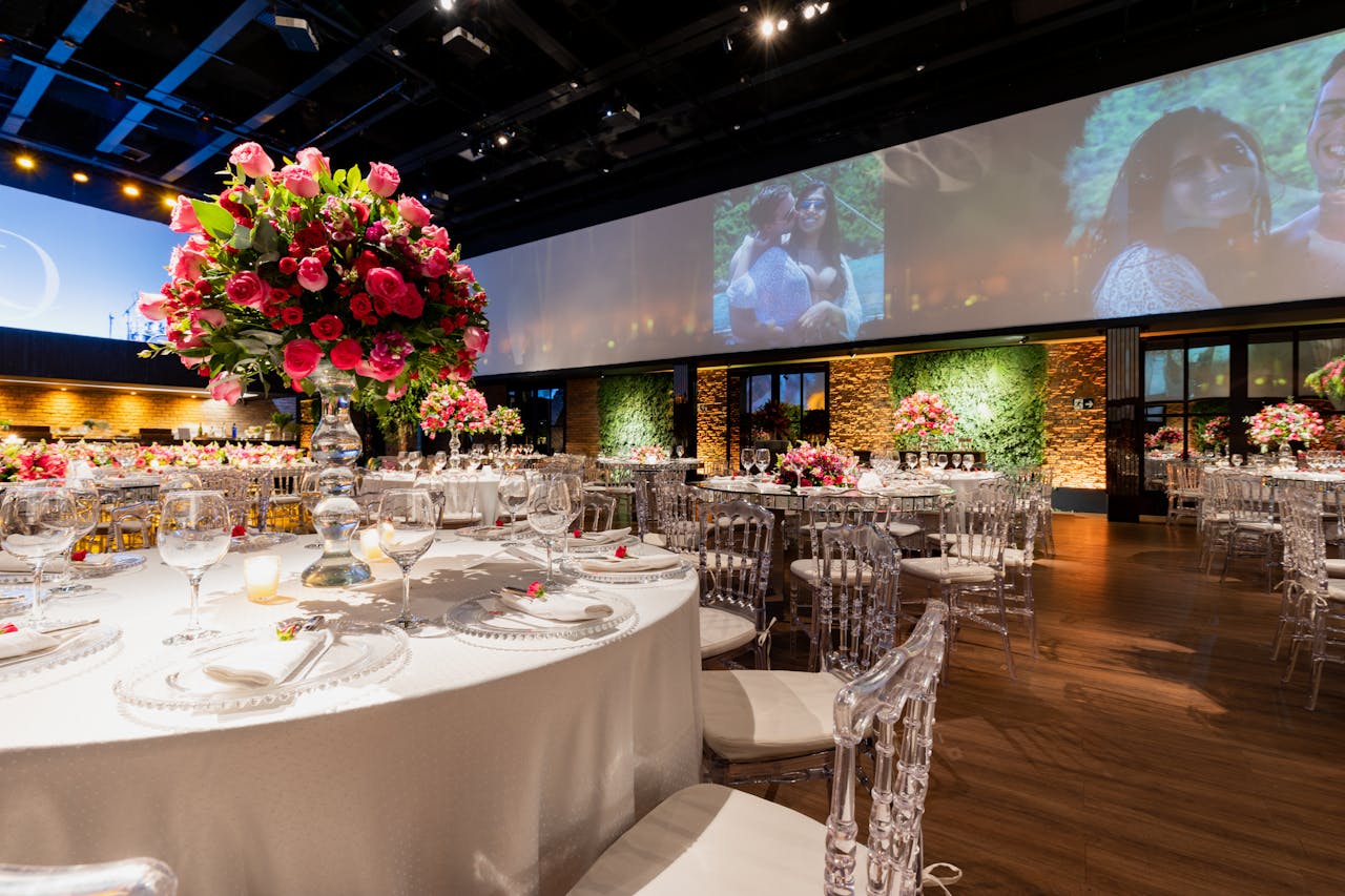 Stunning wedding reception setup with elegant floral centerpieces and ambient lighting.