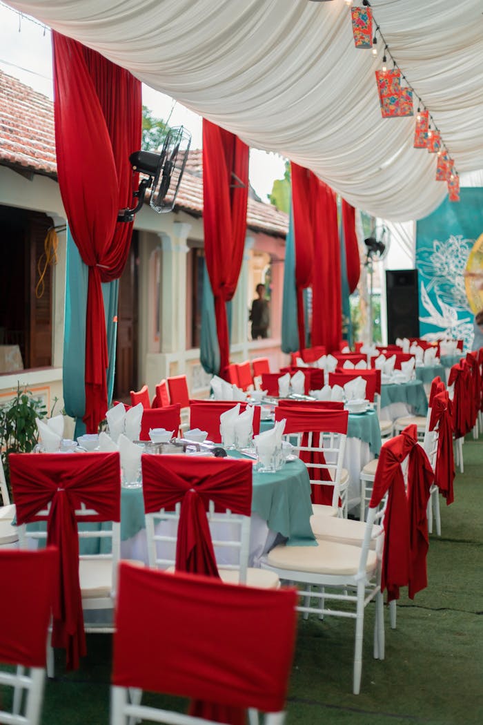 Luxurious outdoor banquet setup with red and white decor, perfect for events.